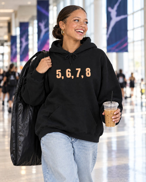 Lifestyle photo of the 5, 6, 7, 8 Puff Hoodie in Black