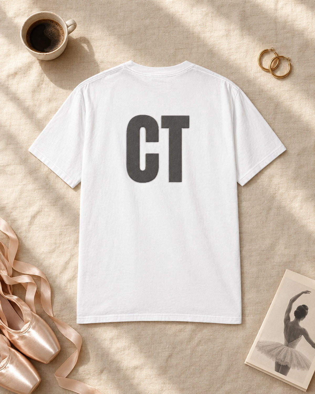 Flat lay of the CT Monogram Puff Tee in White
