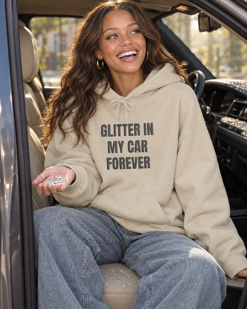 Lifestyle photo of the Glitter in My Car Forever Puff Hoodie in Sand