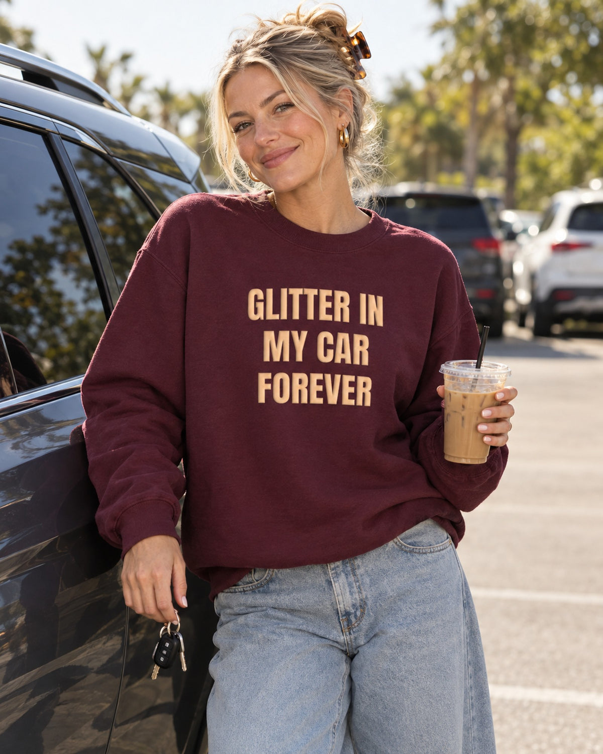 Lifestyle photo of the Glitter in My Car Forever Puff Crewneck in Maroon