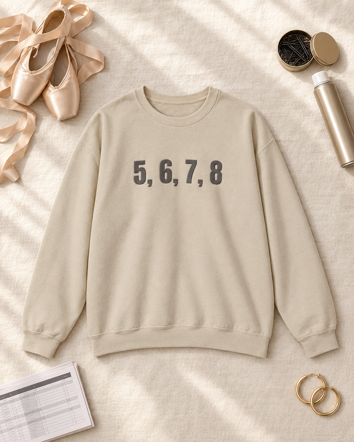 Flat lay of the 5, 6, 7, 8 Puff Crewneck in Sand